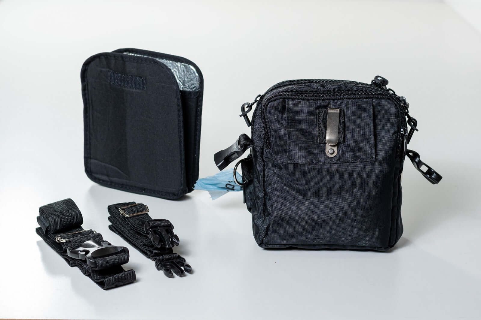 Black dog training crossbody treat pouch with straps on a white background