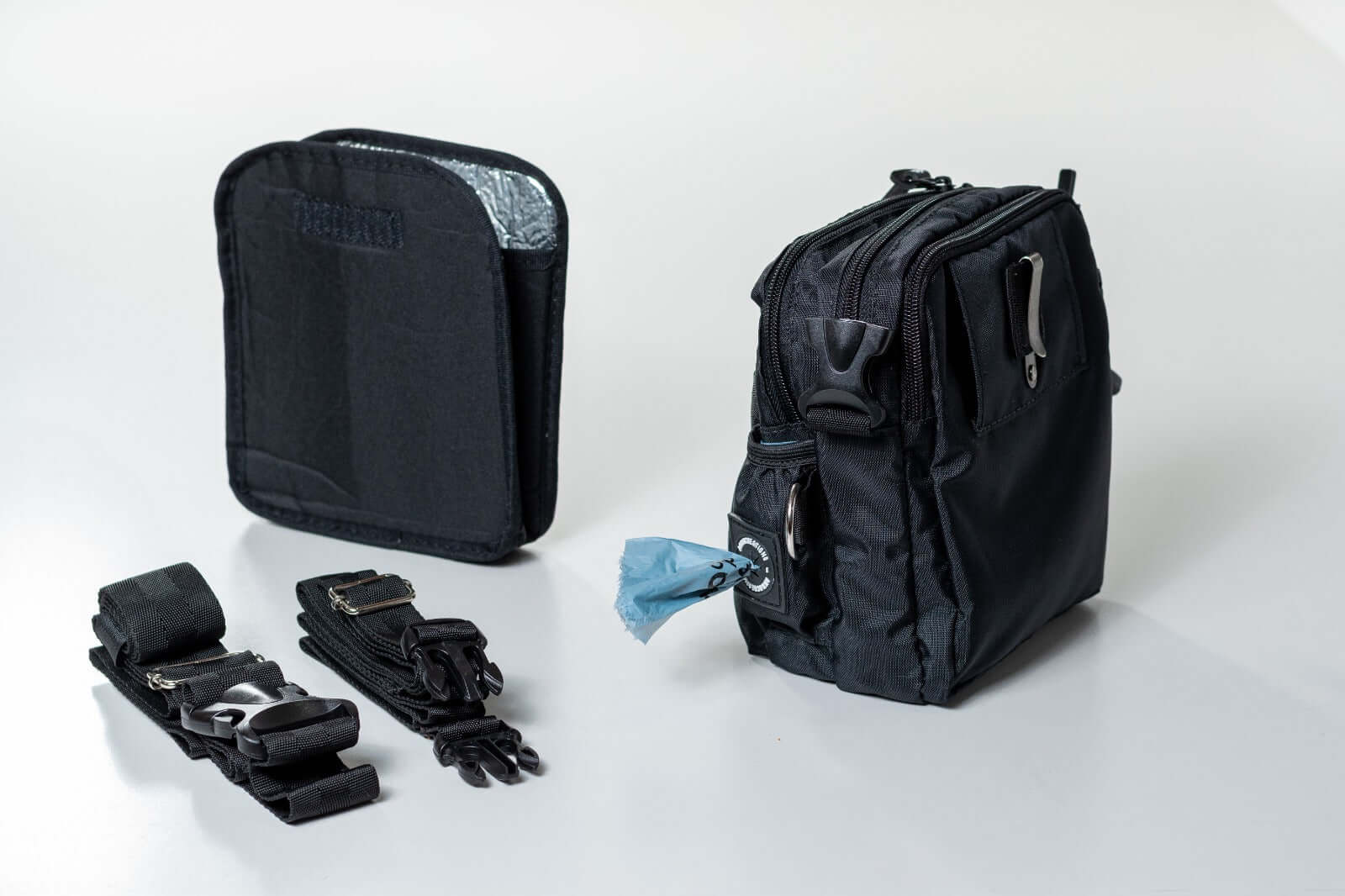 Black crossbody dog training treat bag with straps and an insulated removable for treats sleeve on a white background