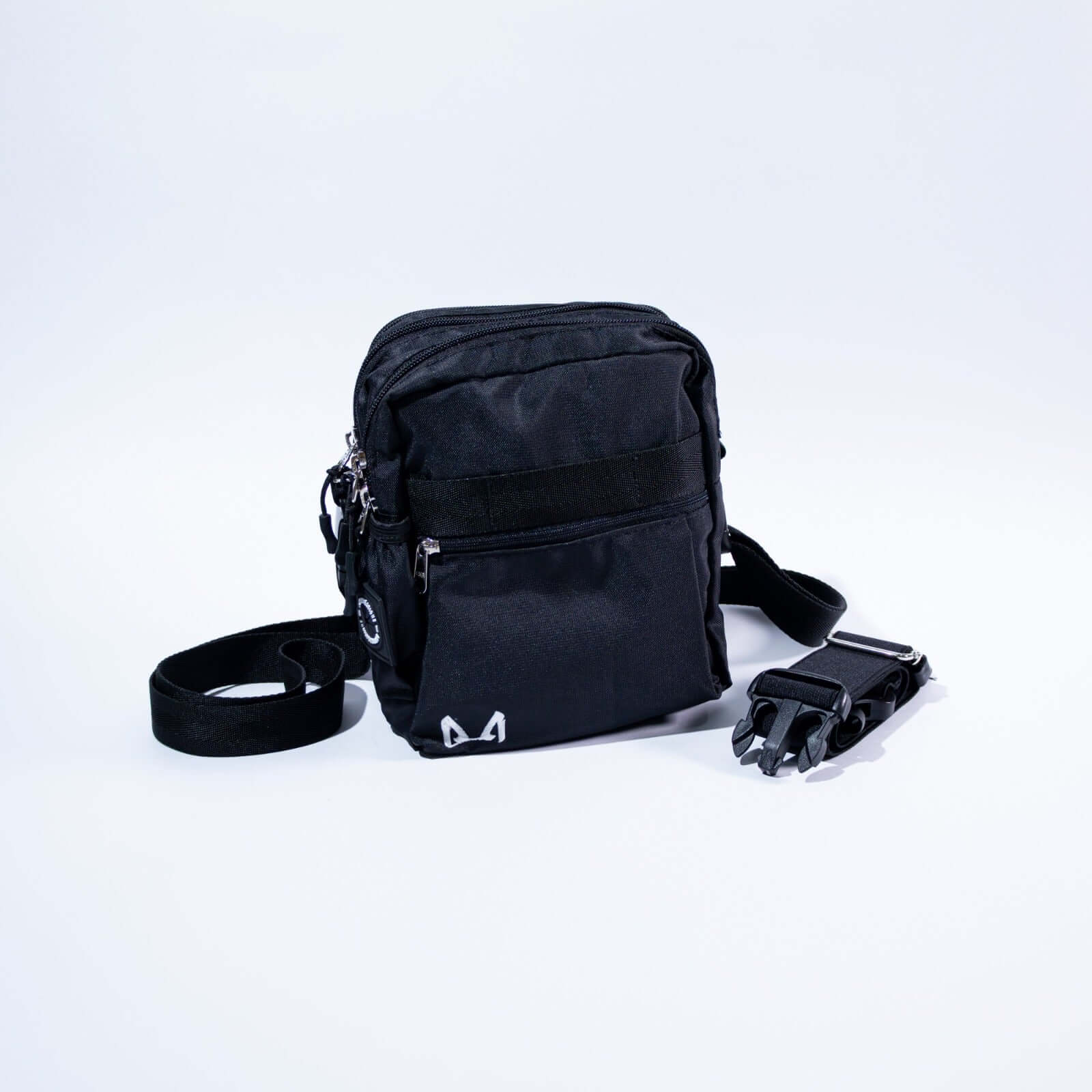 Black crossbody dog training treat bag with a strap on a white background