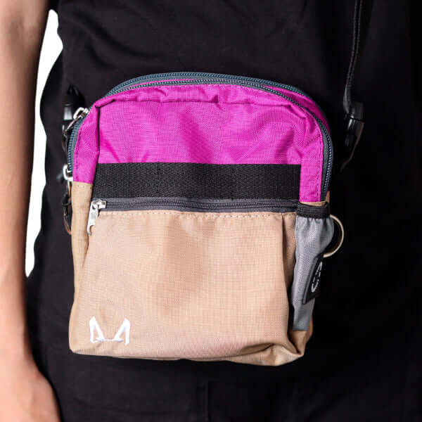 Multicolored lilac and beige pouch with black zipper on a black background