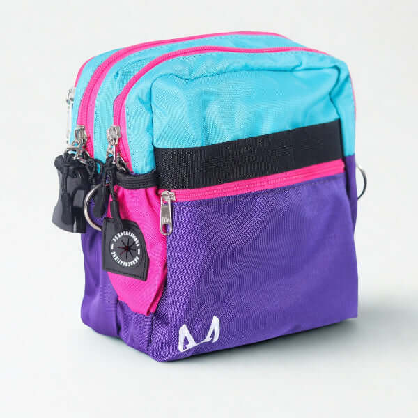 Multicolored purple and pink crossbody dog training bag on a white background