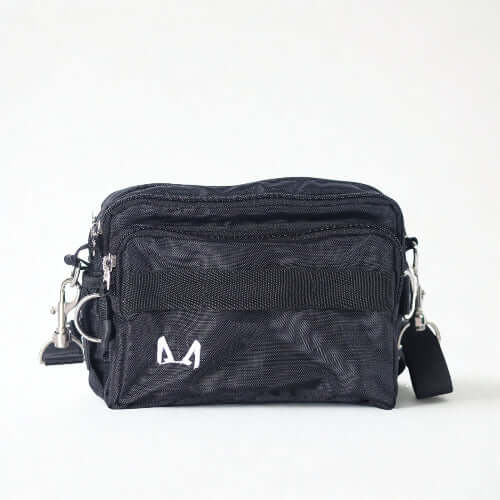 Black fanny pack bag with multiple compartments on a white background