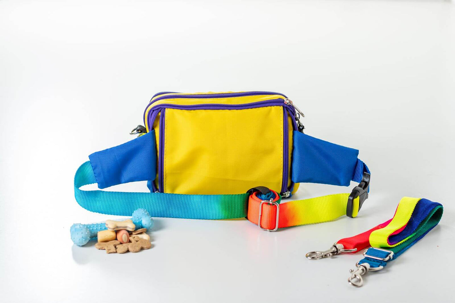 Colorful pride/rainbow fanny pack seen from the bag and collar set on a white background