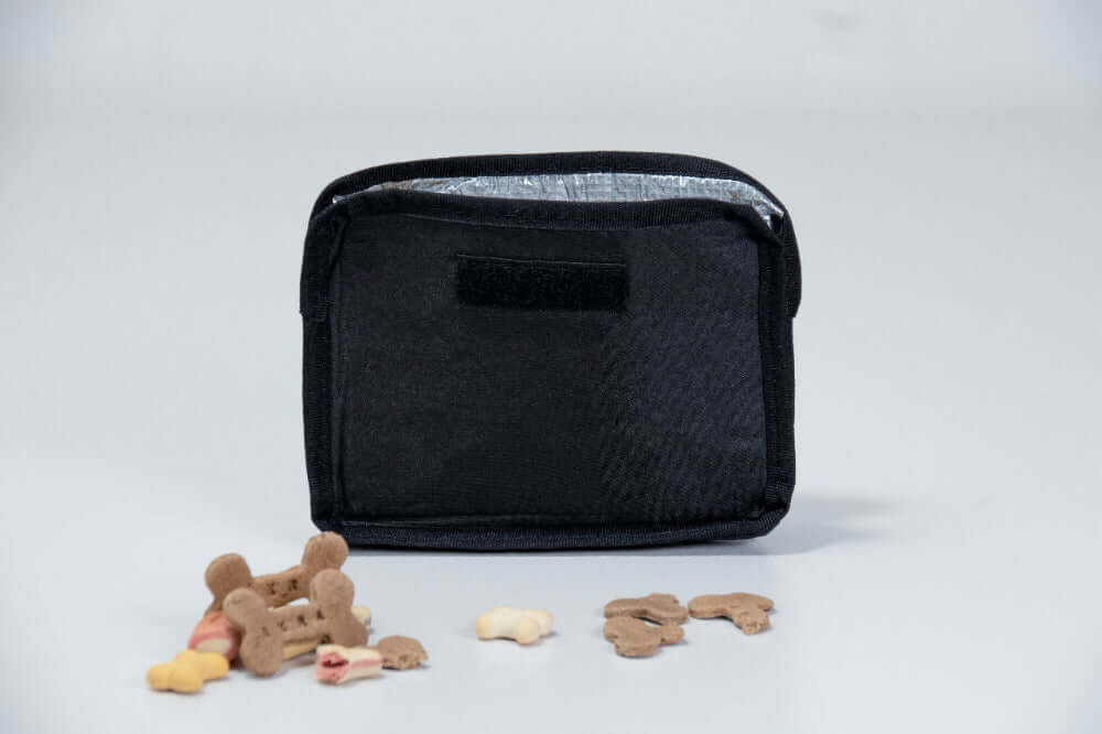 Black insulated sleeve for dog treats on a light gray background