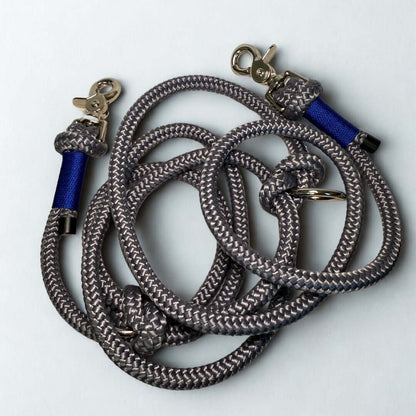 Hands free gray dog leash with blue accents on a white background
