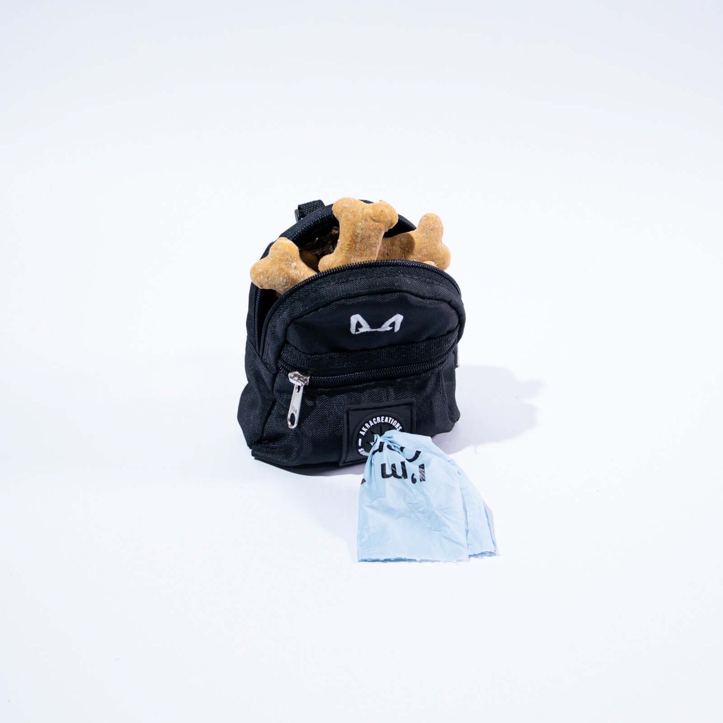 Black dog poop bag and treat holder on a white background
