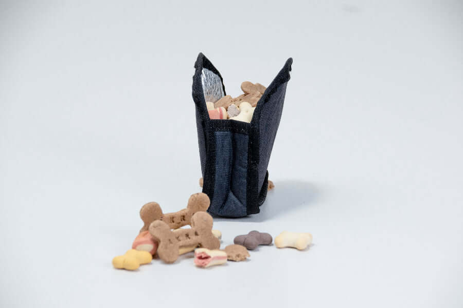 Insulated sleeve for treats with dog bones and chew toys on a white background