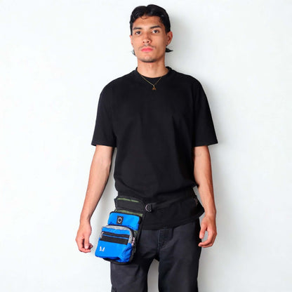 Male model wearing the royal blue and green slim fit dog thigh treat bag