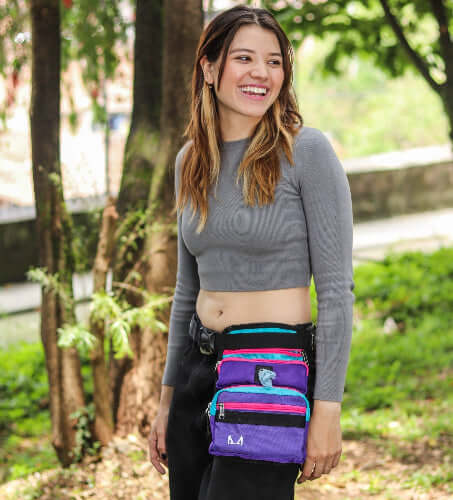 Female model wearing the multicolored slim fit dog thigh treat bag